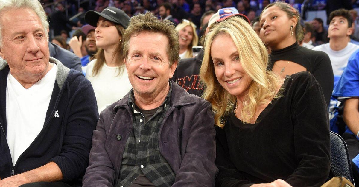 Dustin Hoffman, Michael J. Fox e Tracy Pollan em um jogo de esportes